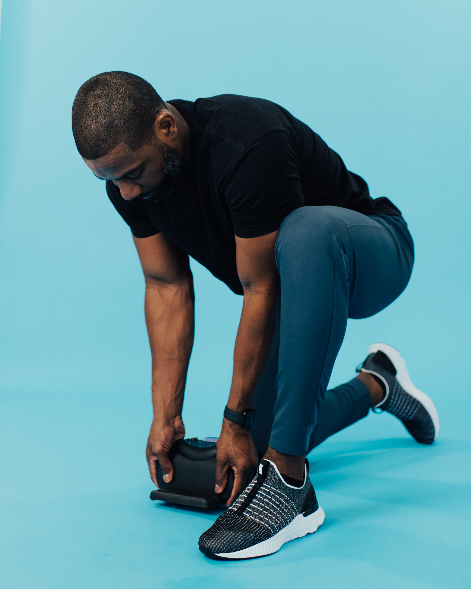 Man kneeling and picking up the compact iGel neck stretcher
